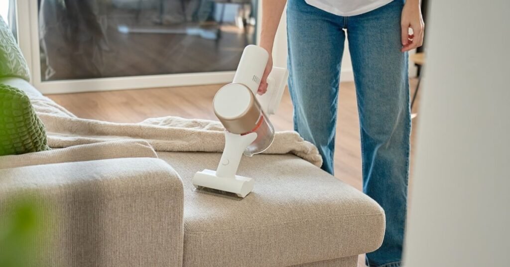 Toronto homeowner cleaning upholstery sofa fabric at home using microfiber cloth and spray solution - TidyUp HandyCrew guide 2026
