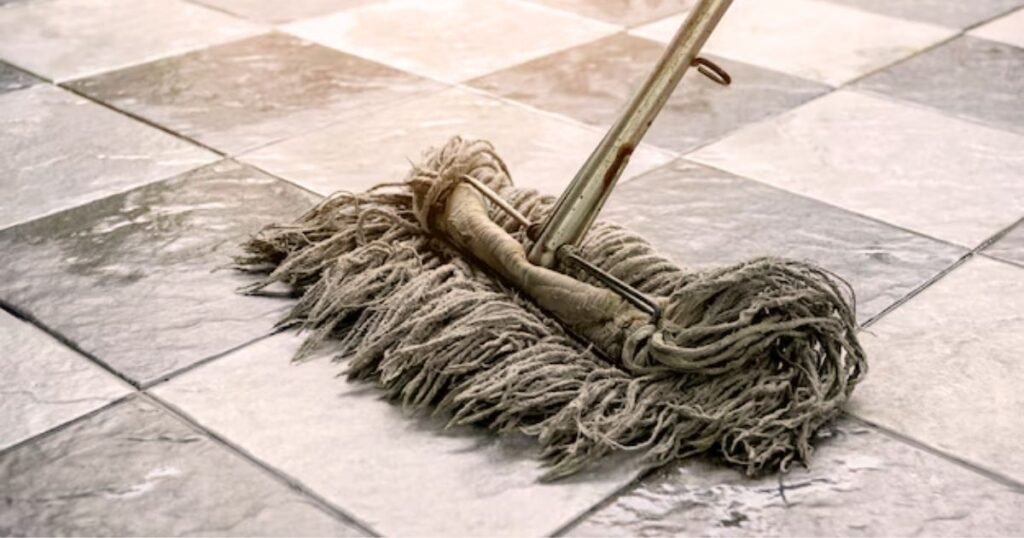 pH neutral floor cleaner beside mop on clean flooring
