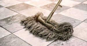 pH neutral floor cleaner beside mop on clean flooring